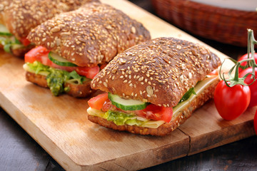 Vegetarian sandwich with pesto on wooden background