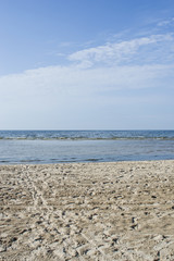 light clouds over Baltic sea near shoreline