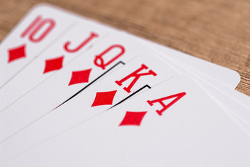 Set of Diamonds suit playing cards on wooden desk