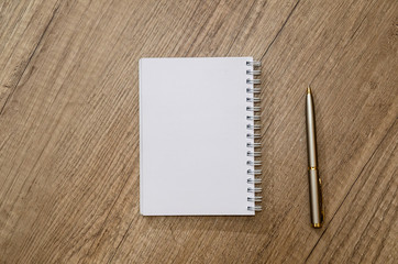 empty notepad with pen on desk