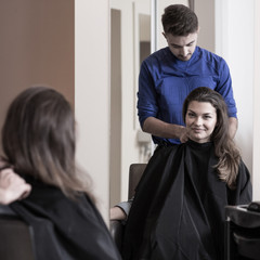 Male hairdresser and attractive woman