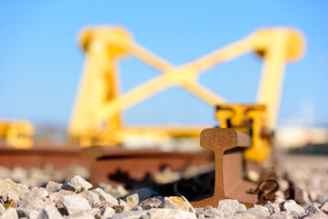 Bright yellow train buffer stop or bumper at the end of a railway track.