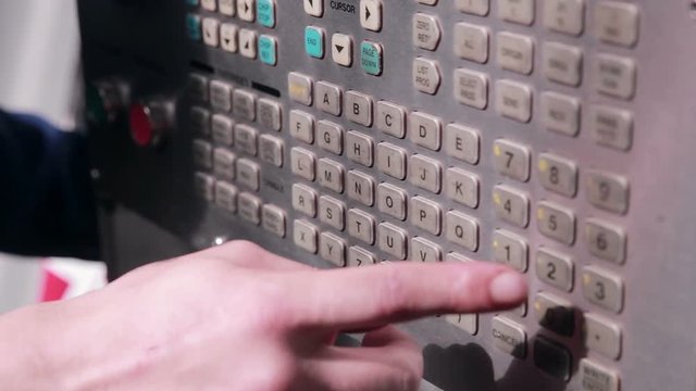 The worker sets the parameters on robotic automsted industrial Machine. HD.