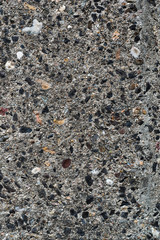 Detail of surface texture with small pebble rock on dirty ground