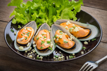 Baked mussels with garlic on plate