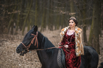 Princess with her horse in the woods