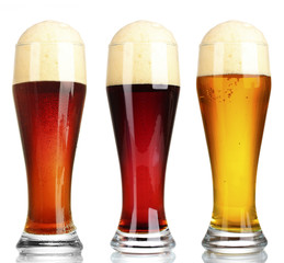 Different types of beer in glasses, isolated on white