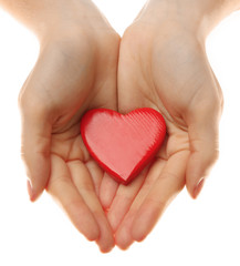 Fototapeta premium Decorative heart in female hands, isolated on white