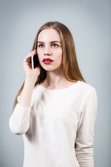 Young woman speaks on the phone