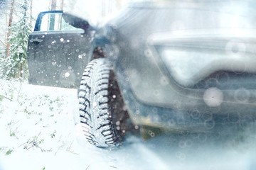 Naklejka na ściany i meble Winter car wheel studs, the concept of winter car ride
