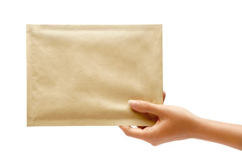 Hand holding envelope. Studio photography of woman's hand holding yellow envelope