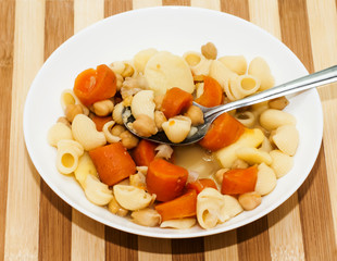 Vegetable soup with pasta, carrots and chickpeas