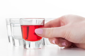 Woman's hand reaching for a glass of alcohol drink.