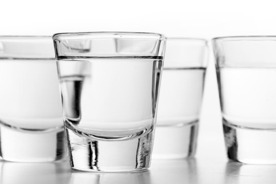 Glasses of vodka on white background. Alcohol