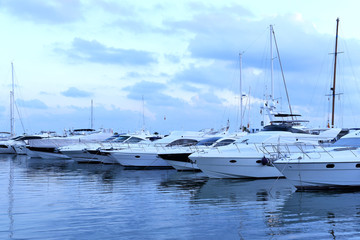 Yacht harbor after the sunset, blue hour. Pastell colored light and anchored boats, quiet scene.