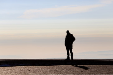 man admires the view from the top of a mountain