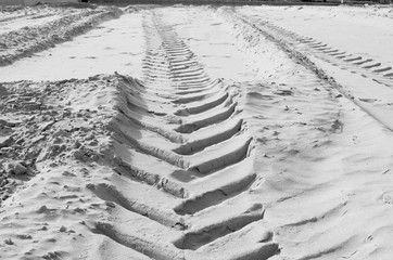 Vehicle footprint on sand in black and white