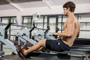 Man working out on rowing machine