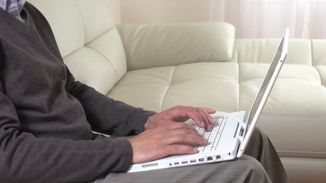 Man hands typing on laptop.