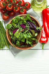 Fresh green salad with spinach ,ruccola,lettuce on wooden table.