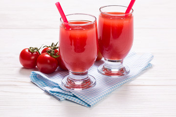 Tomato Juice and Fresh Tomatoes on a White Wooden Background