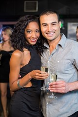 Smiling couple drinking champagne