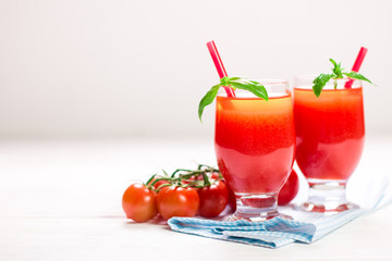 Tomato Juice and Fresh Tomatoes on a White Wooden Background