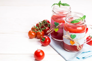 Tomato Juice and Fresh Tomatoes on a White Wooden Background