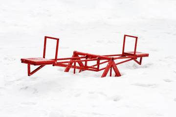 old red iron carousel rocking empty in winter day