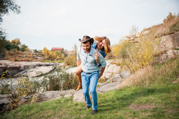 couple hugging each other near a mountain river