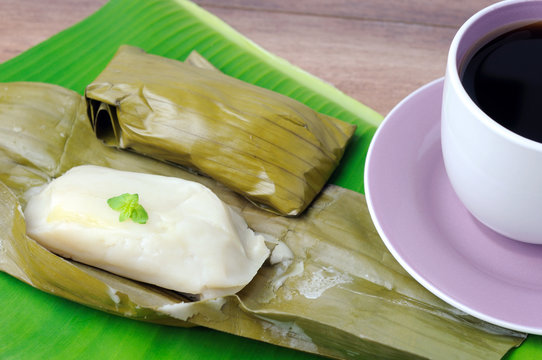 Kuih lepat pisang or also known as  Steam banana parcels cake with a cup of coffee, Kuih lepas pisang is a traditional Malaysian cake.