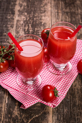 Tomato Juice and Fresh Tomatoes on a Wooden Background