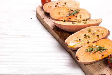 Raw sweet potatoes slice  on wooden background closeup