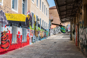 Fototapeta na wymiar A sidestreet in Monastiraki, Athens, decorated with graffiti