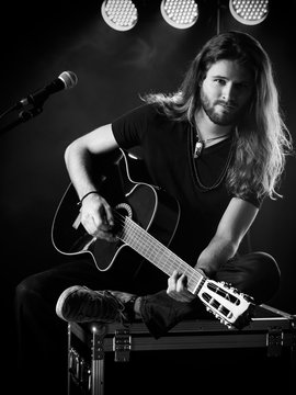 Man playing acoustic guitar on stage