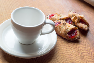 White Cup and cookies on old wooden table