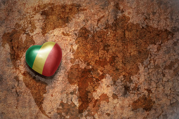 heart with national flag of republic congo on a vintage world map crack paper background.