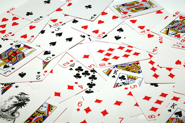 Playing cards laid out on a white background