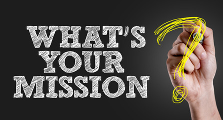 Hand writing the text: Whats Your Mission?