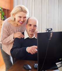 Senior couple talking with someone