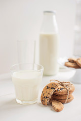 Glass of milk and cookies on the table