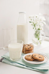 Glass of milk and cookies on the table