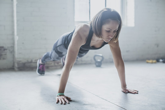 Female athlete doing push-ups in gym