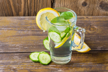 Glass of water on wooden background