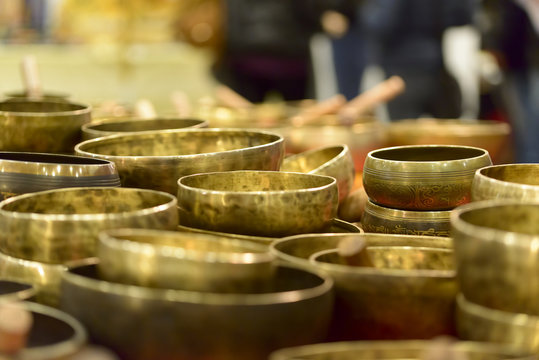 tibetan singing bowls of various sizes in a market
