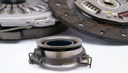A new set of replacement automotive clutch on a white background. Disc and clutch basket with...