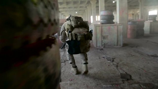 Airsoft , Military Training , a Man in Military Uniform Running with the Weapon's Training Ground Shooting.Storyboard