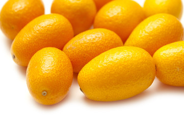 Orange kumquats on a white background