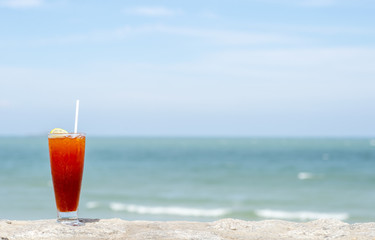 Lemon tea on the rock with blue sae and sky