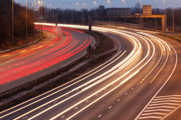 long exposure - motorway highway. Long-exposure sunset over a highway with Instagram vintage faded effect. Speed Traffic at Dramatic Sundown Time - light trails on motorway highway at night, long.